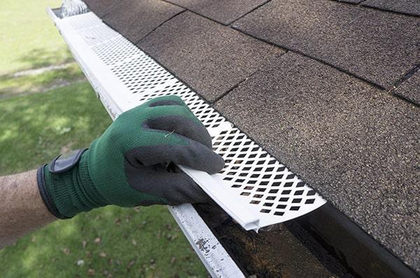 gutter guards enhance rainwater flow by preventing leaves and debris from blocking the gutter channels